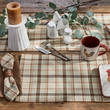 Toffee & Elm Plaid Placemats Set of 4 on wood table with white candle holder and white salt pepper shakers, with Rooster mug.