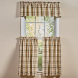 Toffee & Elm Plaid Cafe Tiers and Valance in a beige green and brown plaid pattern, styled on a window against a beige wall.
