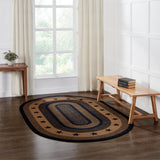 Blackstone Farm Star braided jute rug in black and tan — small oval size shown in a farmhouse entryway setting next to a bench and window