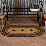 Blackstone Farm Star braided oval rug in black and tan jute with stenciled star border styled in a farmhouse living room