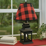 Black lantern lamp with red-check shade and red table runner