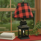 Black lantern lamp with red-check shade and brown wood window trim