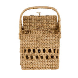 Front view of Cinthia Hyacinth Wine Basket Caddy empty, showing solid woven top panel, open lattice lower weave, and arched carry handle, natural tan water hyacinth
