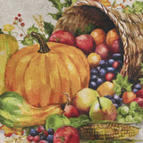 Cornucopia Fall Table Runner 36" filled with fruits, vegetables, and a pumpkin on a fabric background closeup