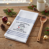 Good Friends Adventure Tea Towel on a wood table with a wooden spoon and Christmas accents