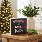 Jingle Bells Plaid Block Sign in a cozy Christmas entryway