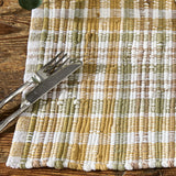 Sage & Mustard Plaid Chindi Placemats Set of 4 closeup with a fork and knife on a wooden surface