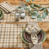 Tinderbox Brown Plaid Placemats layered with matching plaid table runner on a farmhouse wood table, styled with green stoneware, plaid napkin, windmill napkin ring, and eucalyptus