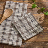 Tinderbox Brown Plaid Dishcloths arranged on a rustic wood farmhouse surface with a wooden spoon and fresh basil — 100% cotton waffle weave dishcloths in brown and oatmeal plaid, set of 3