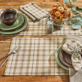 Tinderbox Brown Plaid Placemats styled on a farmhouse wood table with green stoneware, plaid napkins, and a fall pumpkin floral centerpiece — set of 4 cotton placemats in brown and oatmeal plaid