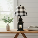 Black lantern lamp with black, tan, cream, and white buffalo-check shade