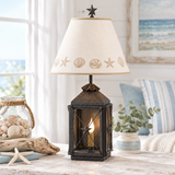 Black lantern lamp with Sea Shell shade in coastal cottage setting