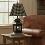 Cambridge black lantern lamp with plaid shade in a cozy reading nook