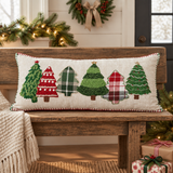 Red and Green Applique Tree Pillow on a Christmas-themed wooden bench